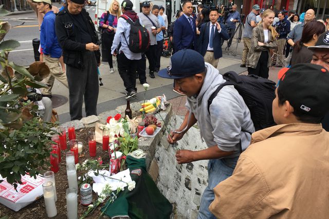 Community members held a vigil on Monday for the four homeless men killed last weekend in Chinatown.